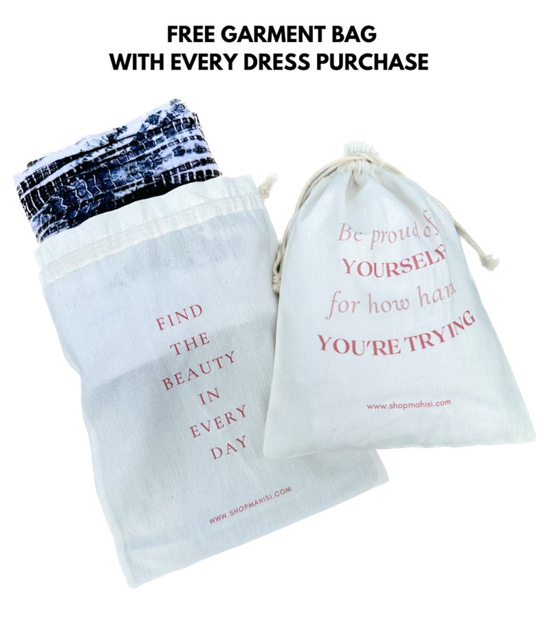 May include: Two white cotton drawstring bags with pink text. One bag says "Find the beauty in every day" and the other says "Be proud of yourself for how hard you're trying". Both bags have the website "www.shopmahisi.com" printed on them.