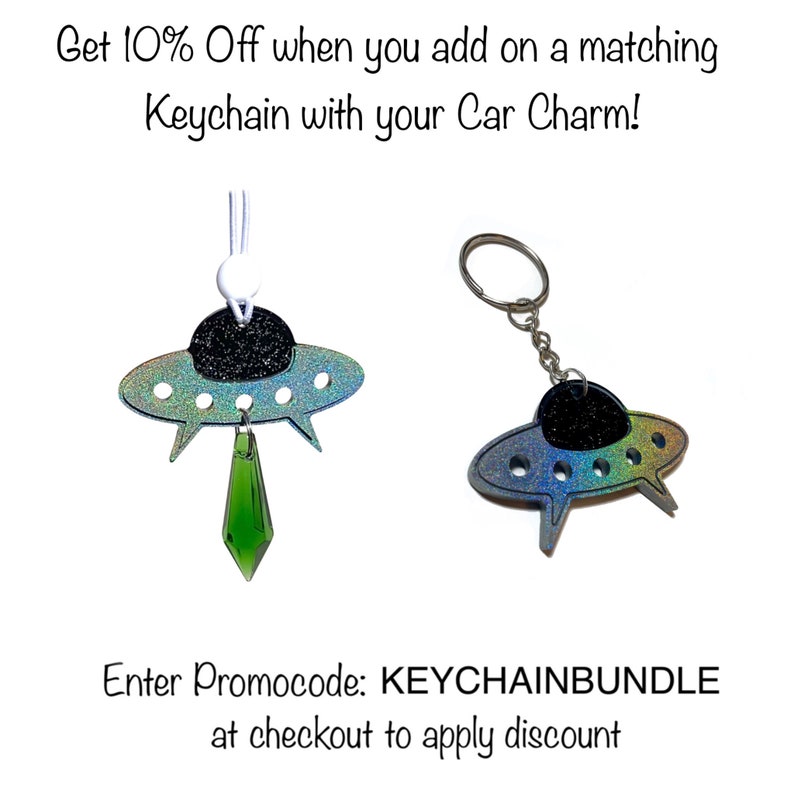 May include: Two iridescent blue and green UFO car charms. One charm is attached to a green crystal pendant and the other is attached to a silver key ring. The text "Enter Promocode: KEYCHAINBUNDLE at checkout to apply discount" is displayed below the charms.