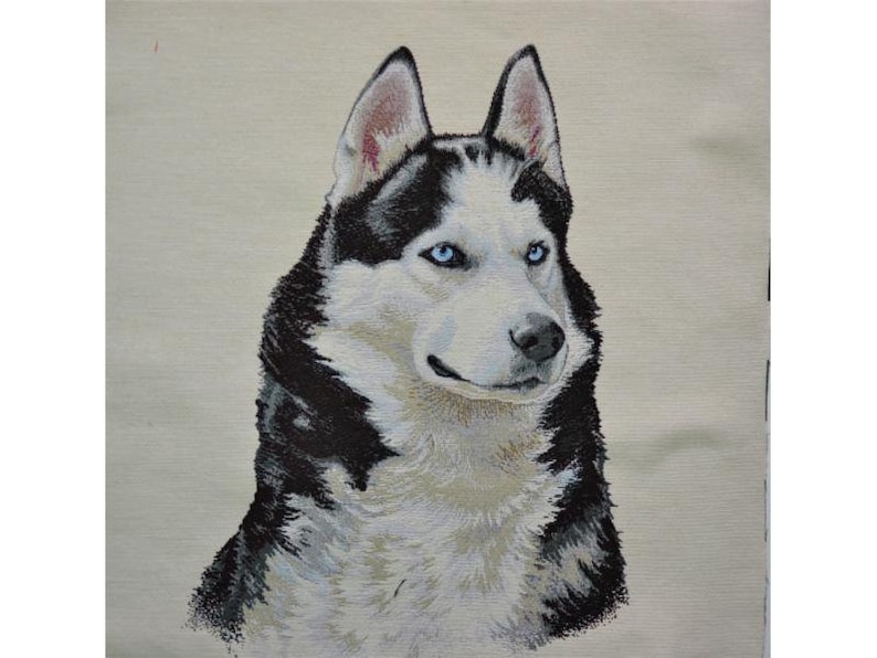 May include: A detailed textile portrait of a Siberian Husky dog. The dog has striking blue eyes, black and white fur, and erect ears. The artwork is set against a neutral background, highlighting the dog's features.