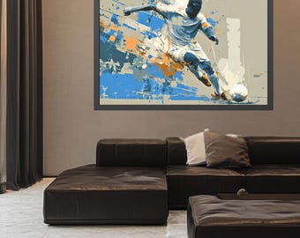 Puede incluir: Impresión artística abstracta de un futbolista pateando un balón. La obra presenta una pose dinámica con salpicaduras de pintura azul, naranja y gris. El jugador lleva un uniforme blanco. La impresión está enmarcada en un marco gris oscuro.
