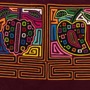 May include: A mola textile featuring two rectangular panels on a dark maroon background. Each panel contains a stylized fruit shape filled with colorful squares and geometric lines in orange, yellow, blue, pink, green, and white thread.