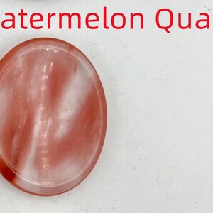 K&ouml;nnte beinhalten: Wassermelonenquarz, ein ovaler Stein mit einer glatten, polierten Oberfl&auml;che in Rosa und Wei&szlig;.