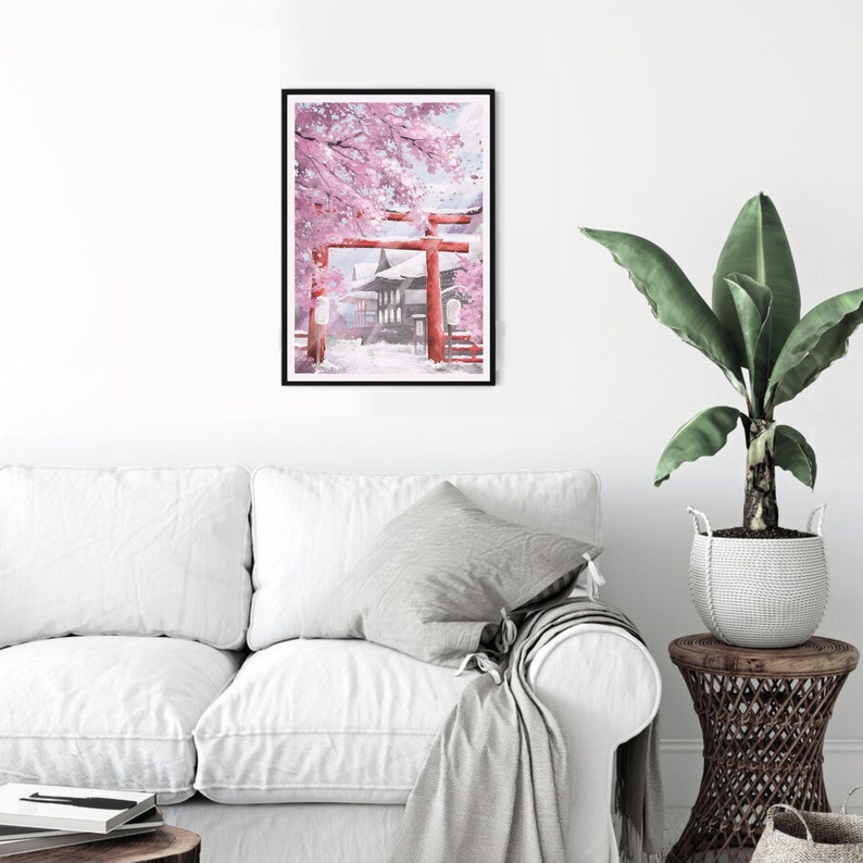 May include: A framed art print depicting a Japanese scene with a red torii gate, traditional buildings, and cherry blossoms. The artwork features a black frame and a serene, snowy landscape with pink and white hues.