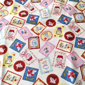 May include: White fabric covered in repeating patterns of cartoon animals in frames and circles. The frames are in various colors, including blue, pink, and yellow, with the word "Sweet" and "Hello" in some. The fabric has a vintage, whimsical feel.