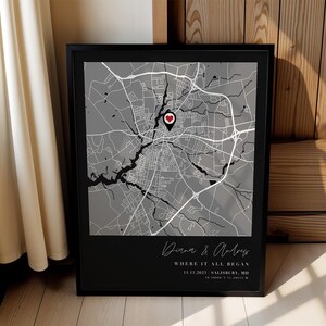 May include: Framed black and white map print featuring a heart-shaped location marker. The map shows a city layout with roads and waterways. Text at the bottom reads "Diana & Andrew, Where it all began, 11.11.2023 Salisbury, MD".