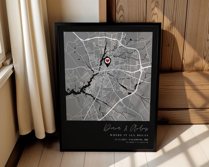 May include: Framed black and white map print featuring a heart-shaped location marker. The map shows a city layout with roads and waterways. Text at the bottom reads "Diana & Andrew, Where it all began, 11.11.2023 Salisbury, MD".