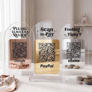 May include: Three clear acrylic QR code stands with arched tops. The stands have metallic gold and rose gold panels with QR codes for Google, PayPal, and Venmo. Text includes "Please Leave Us a Review", "Scan to Pay", and "Feeling Tipsy?"