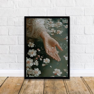 May include: A hand reaches out from a pool of water, surrounded by white flower petals. The water is a deep green color, and the petals are scattered around the hand.