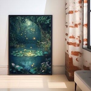 May include: Framed art print showing a tranquil pond scene. The artwork features a dark, dense forest canopy over a pond with lily pads and glowing lights. The water reflects the foliage and lights, creating a peaceful atmosphere.