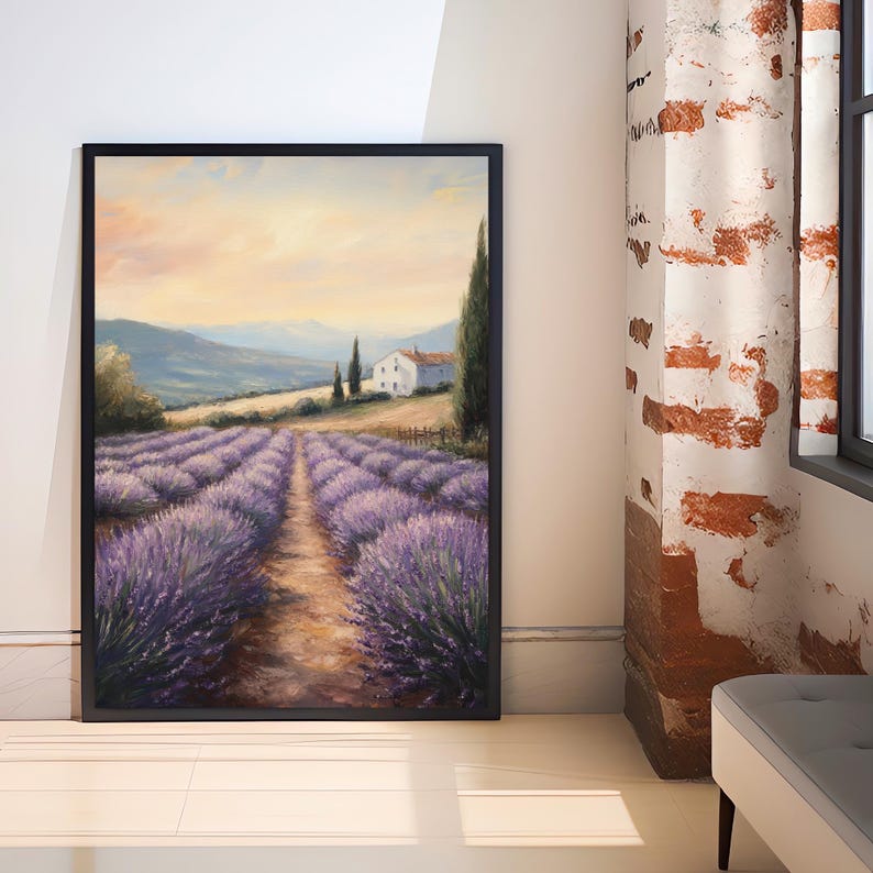 May include: A painting of a lavender field with a small white house in the distance. The field is in full bloom and the lavender is a vibrant purple. The sky is a soft blue with a few clouds. The painting is framed in black.