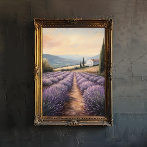 May include: A framed oil painting depicting a lavender field with a small white house in the distance. The painting is set against a backdrop of rolling hills and a clear blue sky. The lavender flowers are in full bloom, creating a vibrant purple hue.