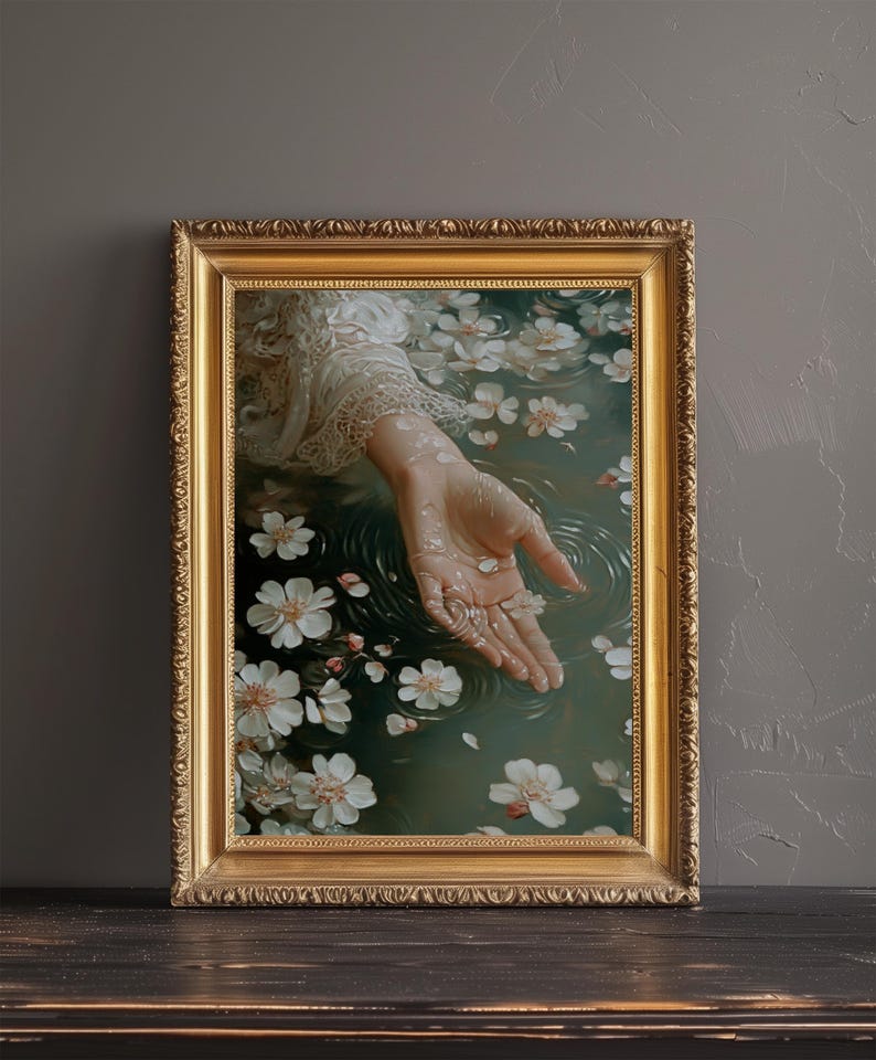 May include: A hand reaches out from a pool of water, surrounded by white blossoms. The water is a deep green, and the hand is pale and delicate. The image is framed in a gold frame.