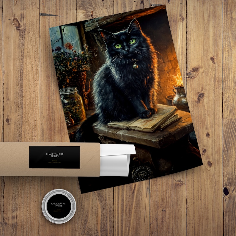 May include: A print of a black cat with green eyes, sitting on a wooden table with books. The cat has a bell collar. The print is in a brown tube with a black label that reads "CHARLTON ART PRINTS". A small round tin with the same logo is also present.