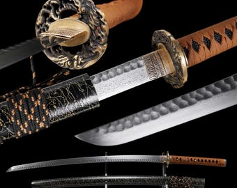 May include: A katana sword featuring a patterned steel blade with a hammered finish, a brown cord-wrapped handle, and an ornate bronze-colored circular guard. The black scabbard has a gold-flecked texture and is wrapped with black and brown cord.