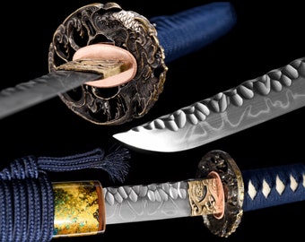 May include: A traditional Japanese katana sword with a blue and gold handle and a silver blade. The blade has a decorative pattern and is sharp. The sword is a beautiful example of Japanese craftsmanship.