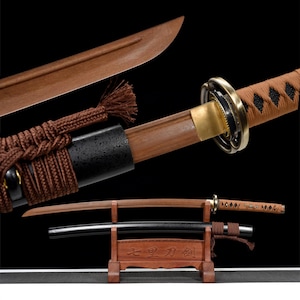 May include: A detailed image of a Japanese katana sword. The blade is a light brown color, with a matching wooden handle and scabbard. The handle is wrapped in brown fabric. The sword rests on a wooden stand.