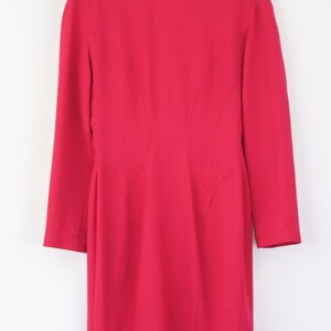 May include: A bright pink blazer with a long sleeve and a fitted silhouette.