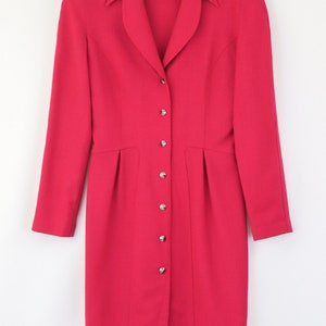 May include: A long-sleeved, button-up dress in a vibrant pink hue. The dress has a classic collar and a fitted silhouette.