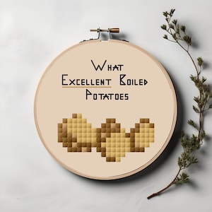 May include: Embroidered hoop art with the text "What Excellent Boiled Potatoes" and a pixelated image of potatoes in brown and beige.