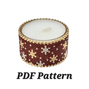 May include: A cylindrical candle holder with a beaded design. The holder is primarily burgundy with gold and white star patterns. The rim is gold, and the candle inside is white. The text "PDF Pattern" is below the candle holder.