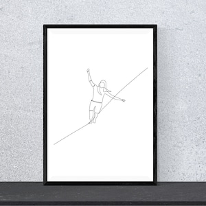 May include: A black framed print of a line drawing of a person walking on a tightrope. The person is wearing shorts and has long hair.
