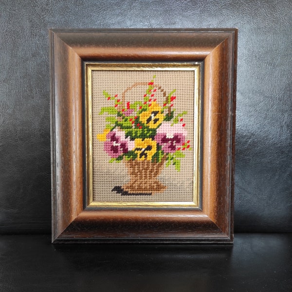 An old wide thick frame for a picture or photo - a wide old frame - a photo frame with an embroidered picture of flowers in a vintage style.