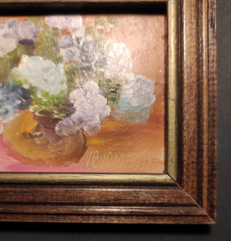 May include: A framed oil painting of a bouquet of purple and blue flowers in a brown vase. The painting is signed "V. Bunny" in the lower right corner.