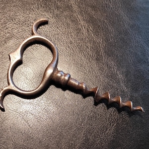 Vintage steel forged corkscrew from the beginning of the last century. Corkscrew Four Finger Steel Pull for your collection, for bar or gift