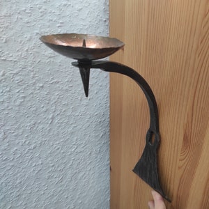 Vintage handmade forged wall candlestick made of iron and brass