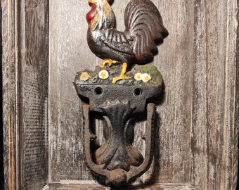 Vintage cast iron door knocker in the shape of a rooster