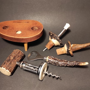 Set of corkscrew and opener and two wine bottle stoppers with handles made of horn