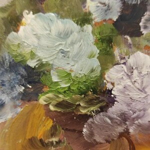 May include: A close-up of an oil painting depicting a bouquet of flowers. The flowers are painted in shades of white, purple, blue, and green. The background is a warm brown colour.
