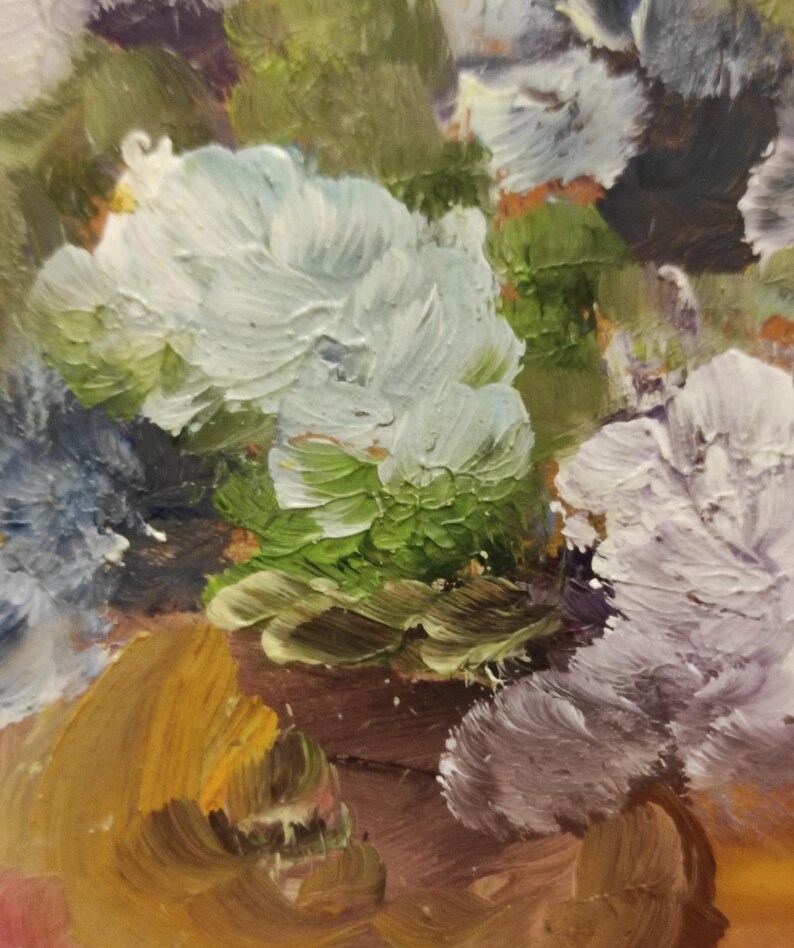 May include: A close-up of an oil painting depicting a bouquet of flowers. The flowers are painted in shades of white, purple, blue, and green. The background is a warm brown colour.