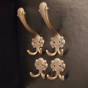 Set of four vintage coat hooks - coat hanger - hallway hooks made of metal with brass finish
