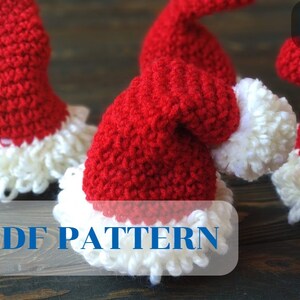May include: Crocheted Santa hats in red and white. The hats have a textured, knitted appearance with a fluffy white trim and pom-pom. The image includes the text "PDF PATTERN".