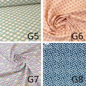 May include: Four fabric swatches with different patterns. The top left swatch has a fan-like design in green, blue, and pink on a light background. The top right swatch is peach with a similar fan pattern. The bottom left swatch has a fan design in pink, purple, and yellow. The bottom right swatch is navy blue with white leaf-like shapes.