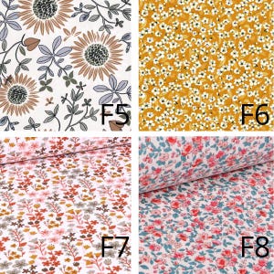May include: Four fabric swatches with floral patterns. Top left: sunflowers and leaves on a cream background. Top right: small white flowers on a mustard background. Bottom left: small flowers on a pink background. Bottom right: small flowers on a pink and blue background.