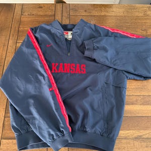 May include: A set of three ceramic mugs with a speckled, matte finish. The mugs are in shades of cream, light gray, and dark gray. Each mug has a simple, minimalist design and a rounded handle.