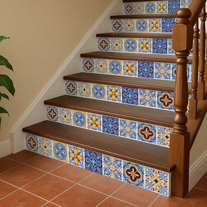 May include: Staircase with decorative tile risers featuring blue and yellow floral patterns. The wooden steps and handrail complement the tile design. A potted plant sits nearby on the terracotta tile floor.