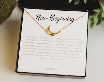 May include: A gold crescent moon necklace in a white box with a message about new beginnings. The message reads "New Beginning" and includes a quote about change and embracing new opportunities.