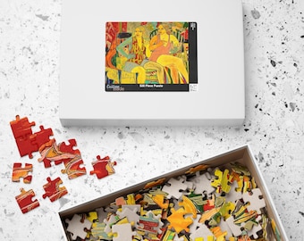 Op de afbeelding: Een witte puzzeldoos met een kleurrijke afbeelding van twee vrouwen. De doos is open en onthult puzzelstukjes. Sommige stukjes liggen verspreid. De afbeelding op de doos zegt "520 Piece Puzzle".