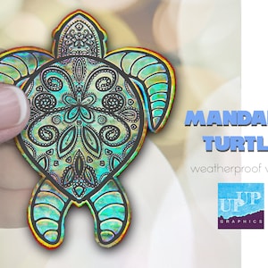 May include: A colorful iridescent vinyl sticker of a mandala turtle design. The sticker is weatherproof and has the text "MANDALA TURTLE" and "weatherproof vinyl" printed below the image. The text "UP GRAPHICS" is printed in blue on a watercolor background below the text.