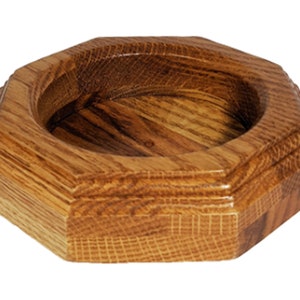 May include: Octagonal wooden bowl with a smooth, natural finish. The bowl has a slightly rounded bottom and a raised lip around the edge.