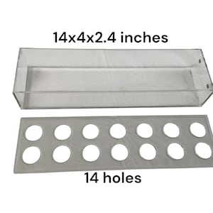 May include: A clear acrylic storage box with 14 holes in the bottom. The box measures 14x4x2.4 inches.