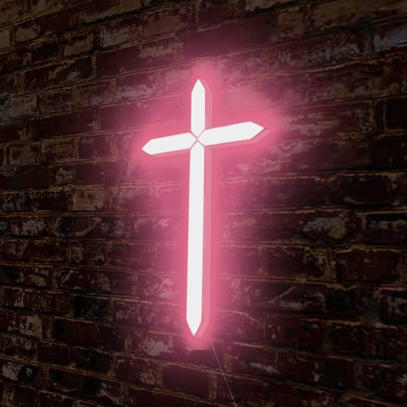 May include: A pink neon cross with a white glow, mounted on a brick wall.