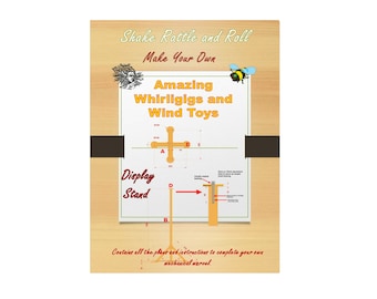 May include: A book cover with a woodgrain background and a white paper overlay. The title is "Shake Rattle and Roll: Make Your Own Amazing Whirligigs and Wind Toys". The cover also includes a diagram of a whirligig and a display stand.