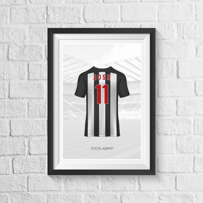May include: A black and white football jersey with the name "JOSH" and the number "11" printed on the back. The jersey is hanging in front of a blurred image of a stadium. The text "TOON ARMY!" is printed below the jersey.