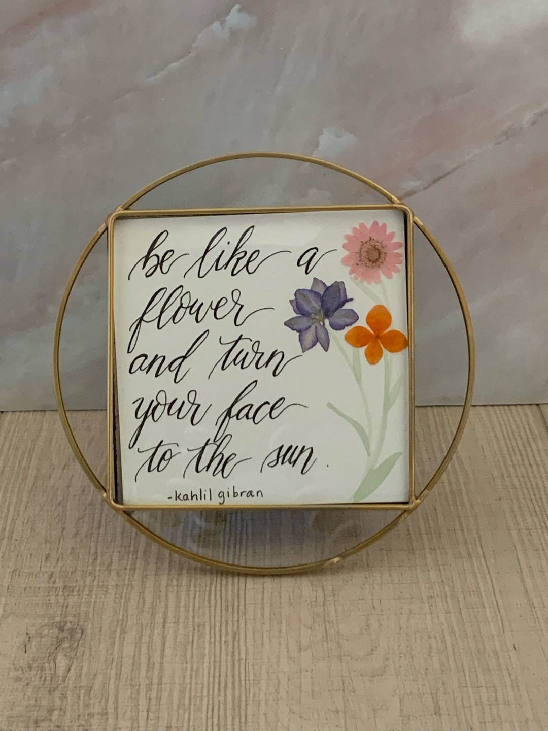 Round Gold-rimmed Frame With Glass. Handwritten Quote With Pressed ...