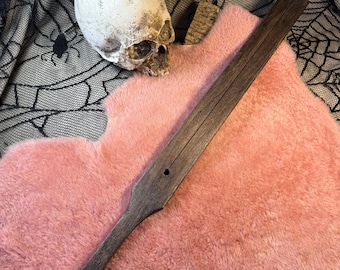 El látigo de madera de doble mejilla