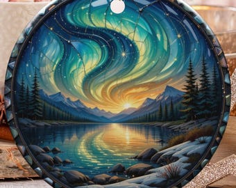 May include: Round Christmas ornament featuring a landscape painting of the Northern Lights over a lake. The ornament has a gold string for hanging. Other holiday decorations include a gold star, a decorative ball, and candy canes.